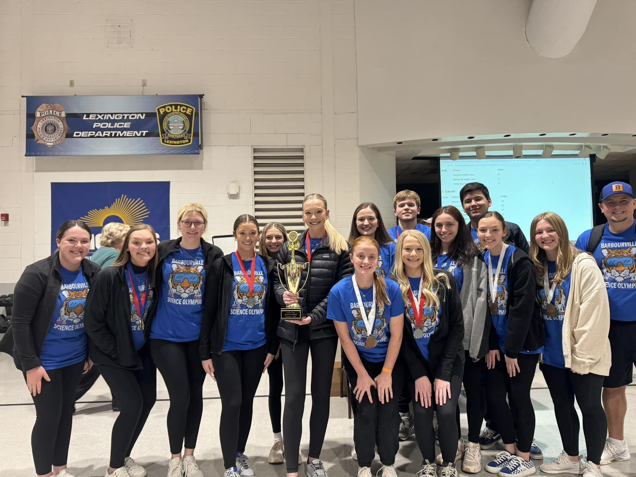 A group pf high school students wearing medals and tshirts that read "Barbourville Science Olympics"